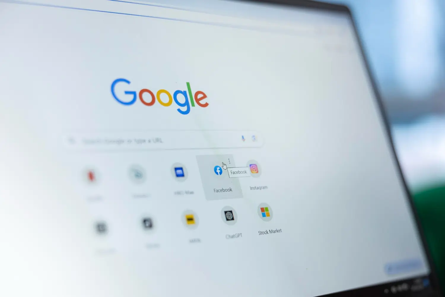 Google homepage displayed on laptop screen with app icons below